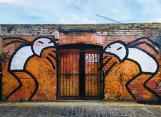 I stepped in vomit today orange and black mural wall