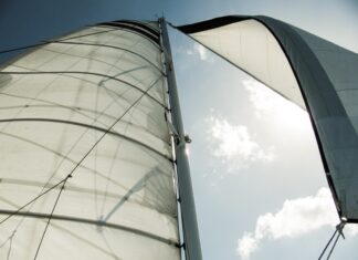 Drawn to the Wilderness white sail boat