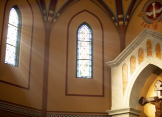 An Admission a statue of jesus on a cross in a church