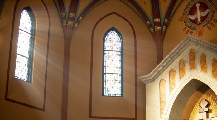 An Admission a statue of jesus on a cross in a church