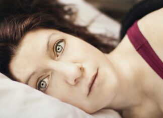 Tied Down a close up of a person laying on a bed