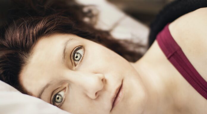 Tied Down a close up of a person laying on a bed