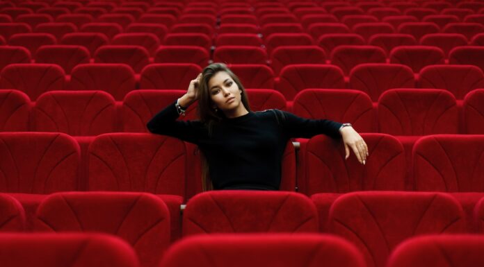Why I Believe Everything woman in black long sleeve shirt sitting on red chair