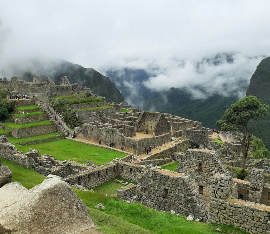 Prendere Lucciole Per Lanterne (To Take Fireflies For Lanterns) brown and gray concrete houses on green grass field under white cloudy sky during daytime