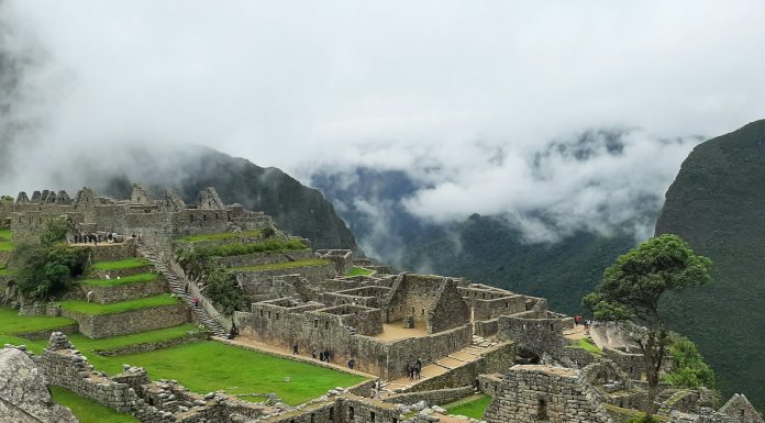 Prendere Lucciole Per Lanterne (To Take Fireflies For Lanterns) brown and gray concrete houses on green grass field under white cloudy sky during daytime