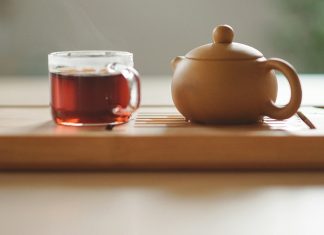WATCHING PORN ON AN UNFORTUNATE WEDNESDAY NIGHT clear glass cup with tea near brown ceramic teapot