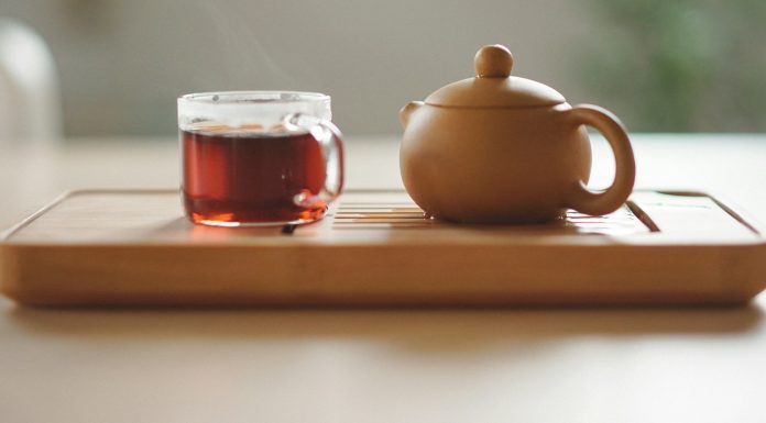 WATCHING PORN ON AN UNFORTUNATE WEDNESDAY NIGHT clear glass cup with tea near brown ceramic teapot