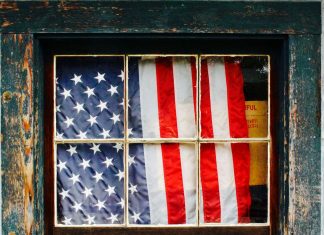 The Hurt Vote United States of America flag on window pane