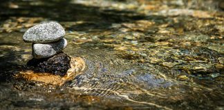 Unmoored gray stones on body of water