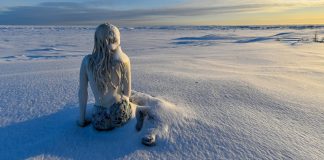 What Do You Call This? a statue of a woman sitting in the snow