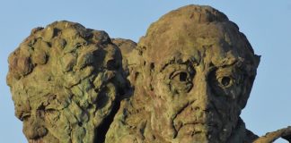 The intimacy of others A statue of a man holding a plant in his hands