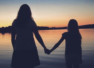 The End of the World silhouette of woman standing on beach during sunset