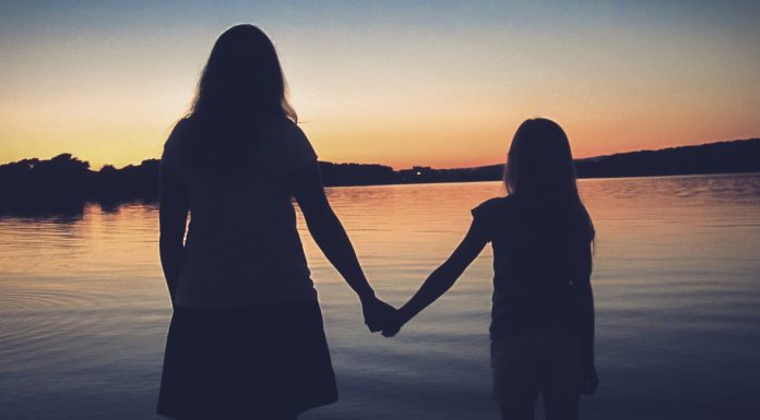 The End of the World silhouette of woman standing on beach during sunset