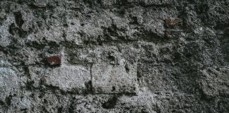 Fear a close up of a stone wall with small holes in it