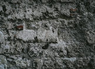 Fear a close up of a stone wall with small holes in it