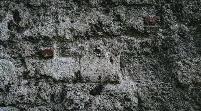 Fear a close up of a stone wall with small holes in it