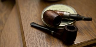 The Pipe two black and brown wooden smoking pipes on table