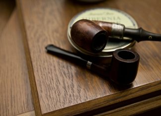 The Pipe two black and brown wooden smoking pipes on table