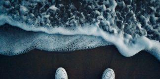 Všetko najlepšie! person in black pants and white sneakers standing on brown sand