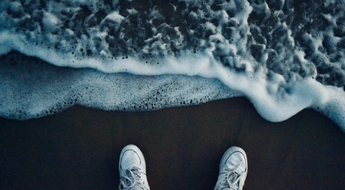 Všetko najlepšie! person in black pants and white sneakers standing on brown sand
