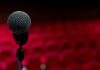 The Woman I Always Knew I Could Be a microphone on a stand in front of a red background