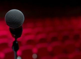 The Woman I Always Knew I Could Be a microphone on a stand in front of a red background