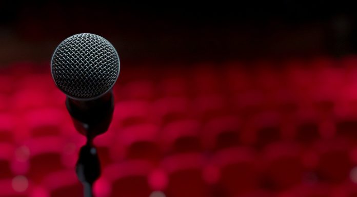 The Woman I Always Knew I Could Be a microphone on a stand in front of a red background